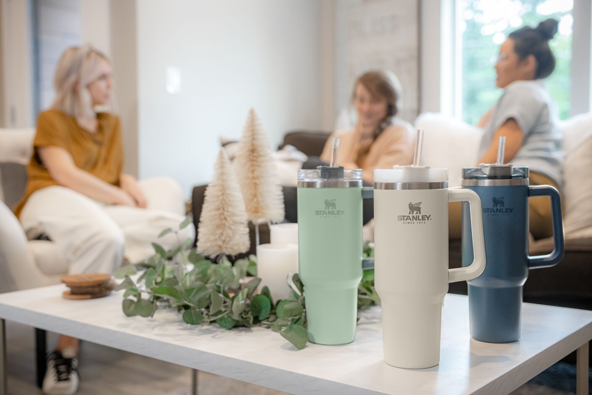 Stanley Adventure Quencher Travel Tumbers in Cream and Desert Sage on a kitchen counter.