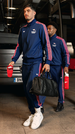 Soccer Players Arriving To Stadium Wearing Arsenal Gear And Carrying Stanley Arsenal Collab Water Bottles