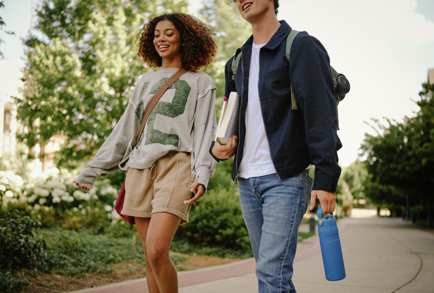 Two Students Walking Holding Stanley Water Bottles